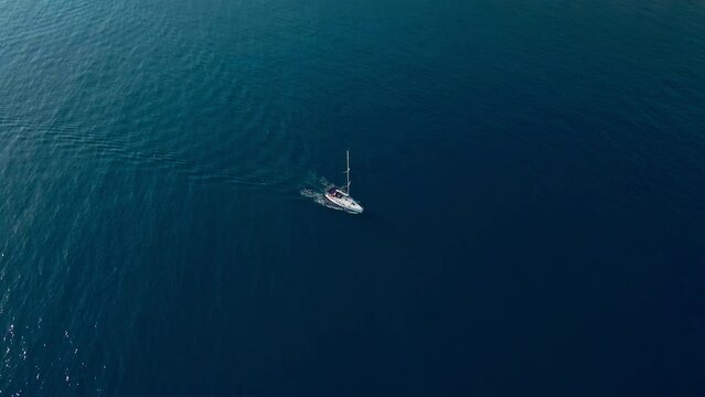Aerial view of sailboat sailing on a deep blue sea. Yacht in blue ocean water, Yachting