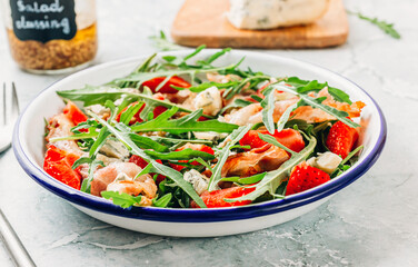 Summer strawberries salad with bacon and blue cheese