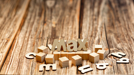 Wooden cubes and the word max on a table. Concepts.copyspace