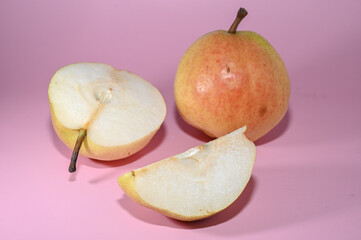Fototapeta na wymiar two juicy pears on a pink background studio shooting 10