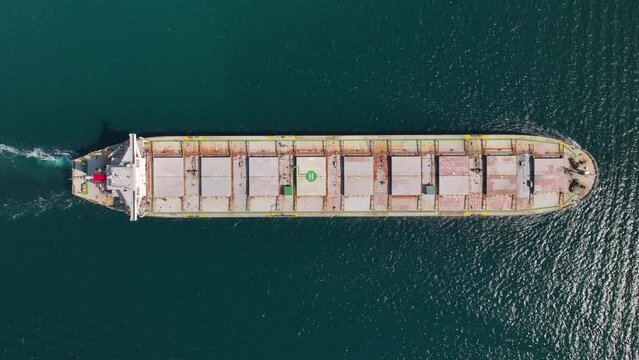  Aerial top view of cargo maritime ship with contrail in the ocean ship carrying container and running for export concept technology freight shipping by ship forwarder mast