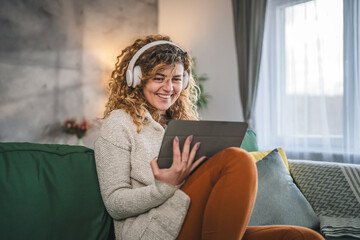 Woman sit at home use digital tablet to watch movie or have video call