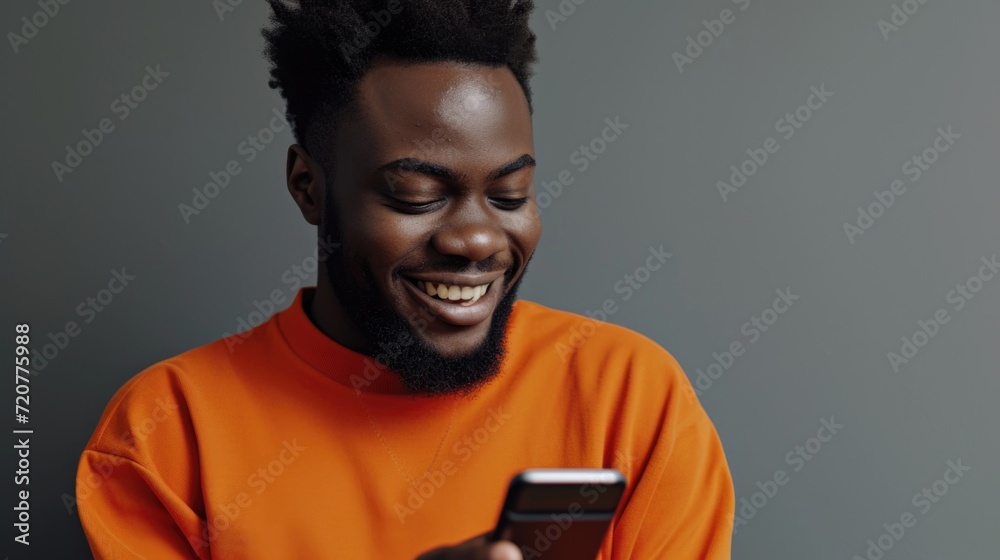Poster a man with a smile on his face as he looks at his cell phone. suitable for depicting modern technolo