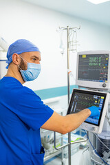 Doctor works with touch screen in the operating room.