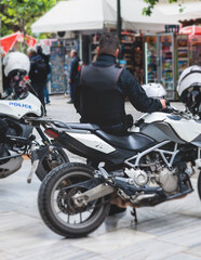 Police squad formation on duty riding bike and motorcycle, maintain public order in the european city streets, group of policemen patrol on motorbikes with "Police" logo emblem on uniform, Europe