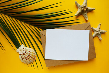 ummer holiday concept. straw hat, palm branch and seashells. white blank