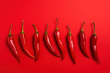 Fotobehang Vibrant Red Chilis on Colorful Background AI Generated © Alex