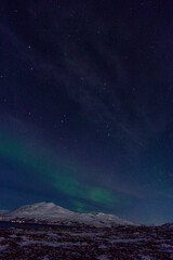 Naklejka na ściany i meble Northern lights night in Tromso in Norway ona cold night in winter 