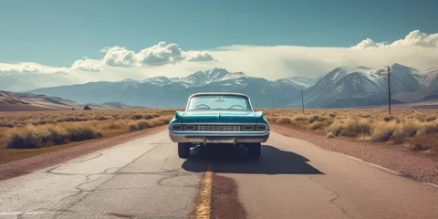 Deurstickers Vintage and retro photo of a classic car parked on a deserted road, with mountains in the backdrop © EOL STUDIOS