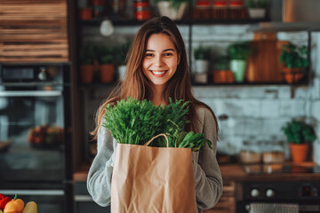 Happy beautiful young woman holding cardboard bag with health shopping in kitchen at home. She bought vegetables for a healthy family lunch.