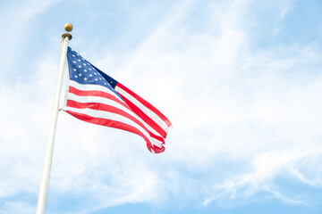 american flag waving against sky
