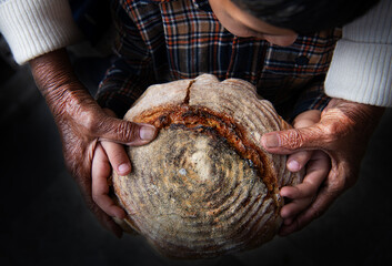 Grandma and grandchild holding handmade artisan bread 