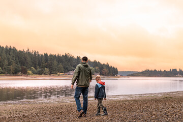 Young father and son child spending time together walking talking in a beautiful nature setting 