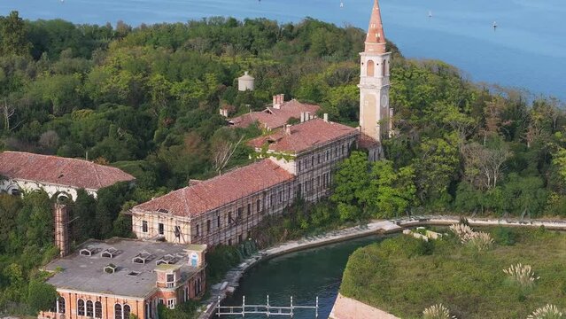 Aerial view of the plagued ghost island of Poveglia in the Venetian lagoon, opposite Malamocco along the Canal Orfano near Venice, Italy.