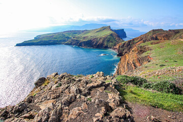 Fototapeta na wymiar Green slopes surrounding a bay at the Ponta de São Lourenço (tip of St Lawrence) at the easternmost point of Madeira island (Portugal) in the Atlantic Ocean