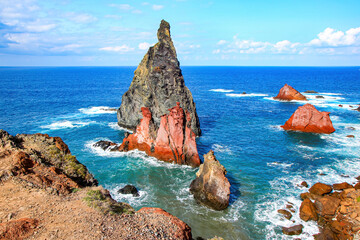 Red rock pillar protruding out of the Atlantic Ocean at the Ponta de São Lourenço (tip of St Lawrence) at the easternmost point of Madeira island (Portugal)
