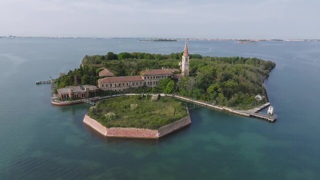 Aerial view of the plagued ghost island of Poveglia in the Venetian lagoon, opposite Malamocco along the Canal Orfano near Venice, Italy.