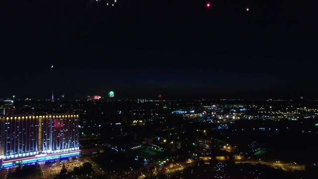 Cityscape with fireworks and smoke at dark night. Aerial view