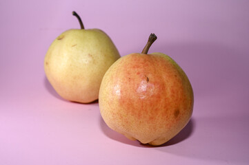 two juicy pears on a pink background studio shooting 1