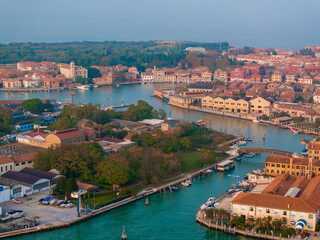 Aerial view of Murano island in Venetian lagoon sea from above, Italy at sunset