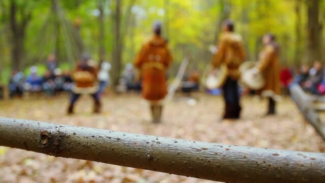 Animators in native suits performs for tourists at autumn day