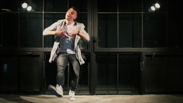 Young man wearing t-shirt moves in break-dance style