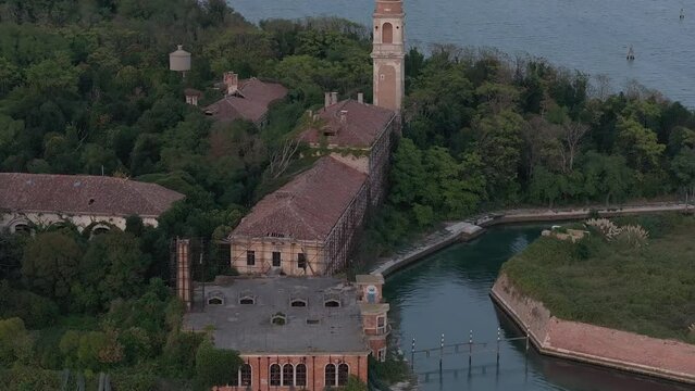 Aerial view of the plagued ghost island of Poveglia in the Venetian lagoon, opposite Malamocco along the Canal Orfano near Venice, Italy.