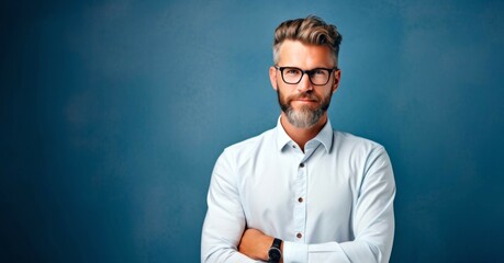 Portrait of a handsome man in glasses on a blue background. - obrazy, fototapety, plakaty