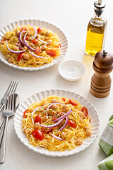 Spaghetti squash with chickpeas and tomatoes topped with red onion, low carb vegan recipe idea