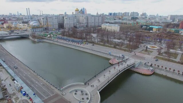Cityscape with people walk by bridge near Bolotnaja square