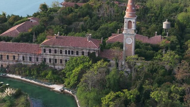 Aerial view of the plagued ghost island of Poveglia in the Venetian lagoon, opposite Malamocco along the Canal Orfano near Venice, Italy.