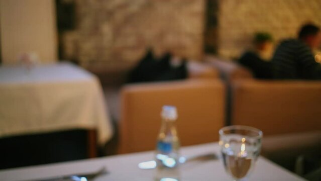 People touches goblets with white vine at restaurant