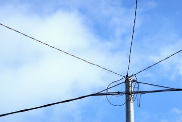 electric cables on the pole with blue sky