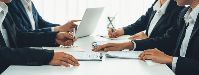 Two business executive in boardroom discuss term and company merging agreement, review corporate...