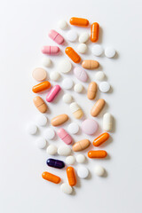 Varity of pills and medicine tablets and capsules on white, medication and overmedication problem concept