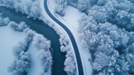 Aerial top view of snow road winter time over blue river
