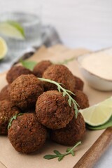 Delicious falafel balls and arugula on table, closeup