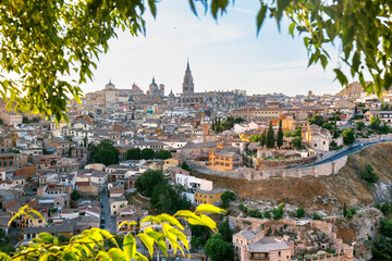 Panoramic view of Toledo in a green foliage frame, Spain