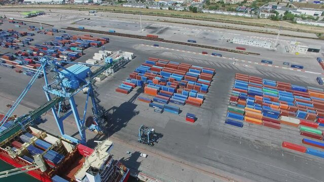 Mourepiane container terminal and barge on moorage under crane 