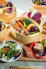 Japanese food in bamboo containers, closeup of a Japanese meal.