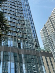 Fototapeta premium Skyscrapers in city,Full frame shot of building, View of cityscape against sky during sunset,Vehicles on road in city against sky.Buildings in city against cloudy sky Sunset behind the new skyline 