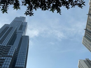 Obraz premium Skyscrapers in city,Full frame shot of building, View of cityscape against sky during sunset,Vehicles on road in city against sky.Buildings in city against cloudy sky Sunset behind the new skyline 