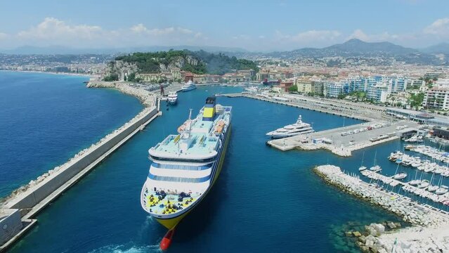 Cityscape with ferryboat Mega Express Two sails in port of Nice 
