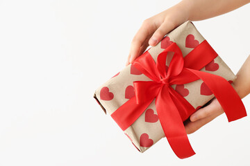 Female hands with gift box on white background. Valentine's Day celebration