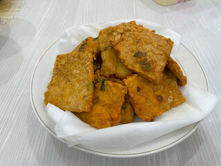 Fried tempe in a white plate. delicious and crunchy