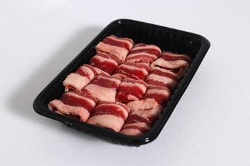 Sliced raw beef isolated on a white background