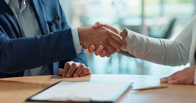 Business people, sign contract and handshake for agreement, legal deal and partnership negotiation in office. Shaking hands, signature on documents and closeup of lawyers in collaboration in meeting