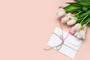 Bouquet of beautiful tulips and envelope on pink background. International Women's Day