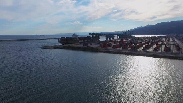Seascape and container terminal Voltri Europa with barge on moorage