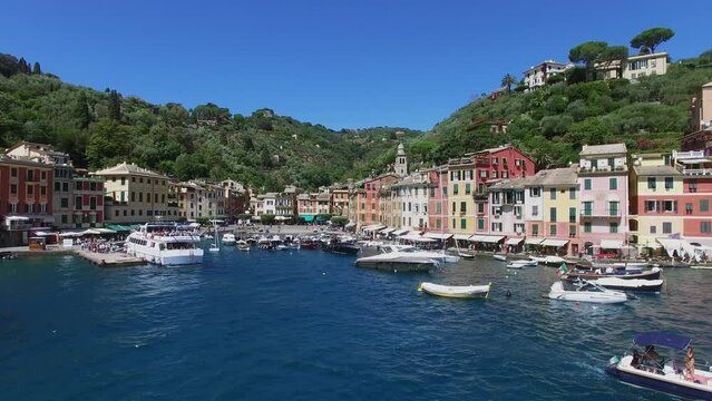 Many boats are in Marina of Portofino near coastal town at summer